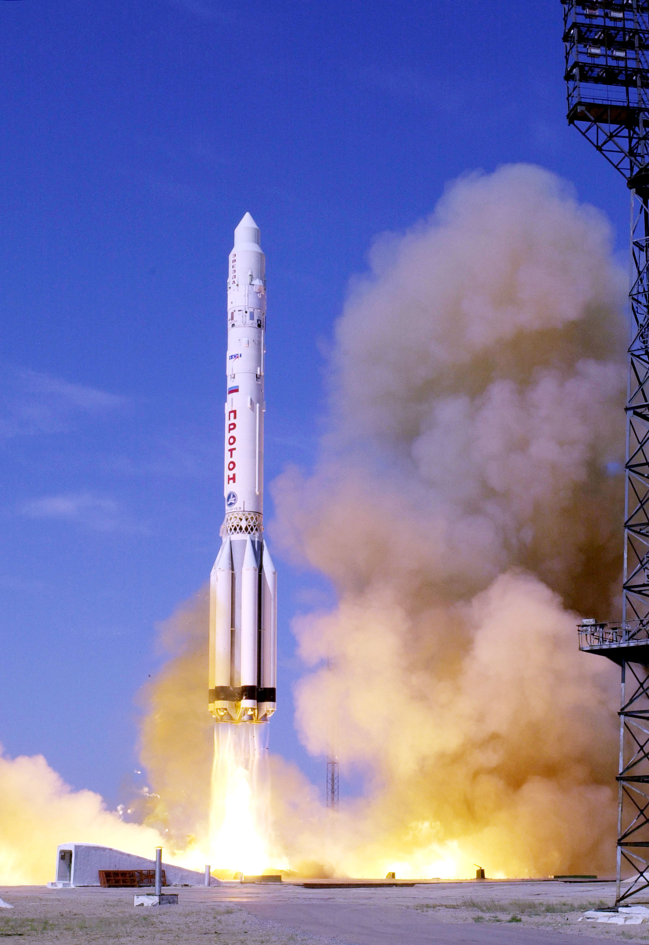 Photo credit; Scott Andrews/NASA Caption; A proton booster lifts off from the Bykanor Cosmodrome carrying the Zvesda, the third element of the International Space Staion Date; 12 July, 2000