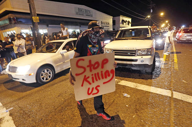 Protestors congregate at N. Foster Dr. and Fairfields Ave., the location of the Triple S convenience store in Baton Rouge, La., Wednesday, July 6, 2016. Alton Sterling, 37, was shot and killed outside the store by Baton Rouge police, where he was selling CDs. (AP Photo/Gerald Herbert)